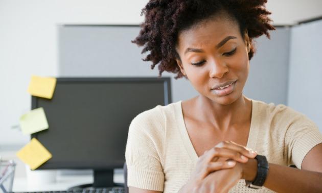 Black woman looking at watch