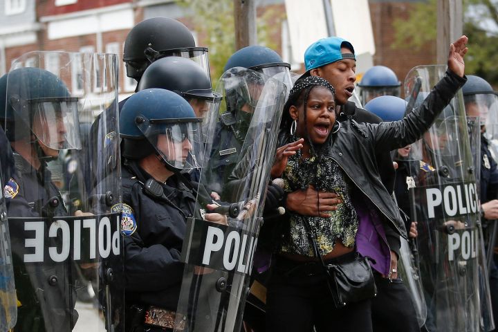 Woman Held Back By Man At Protest