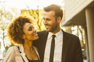 Outdoor portrait of flirting elegant couple