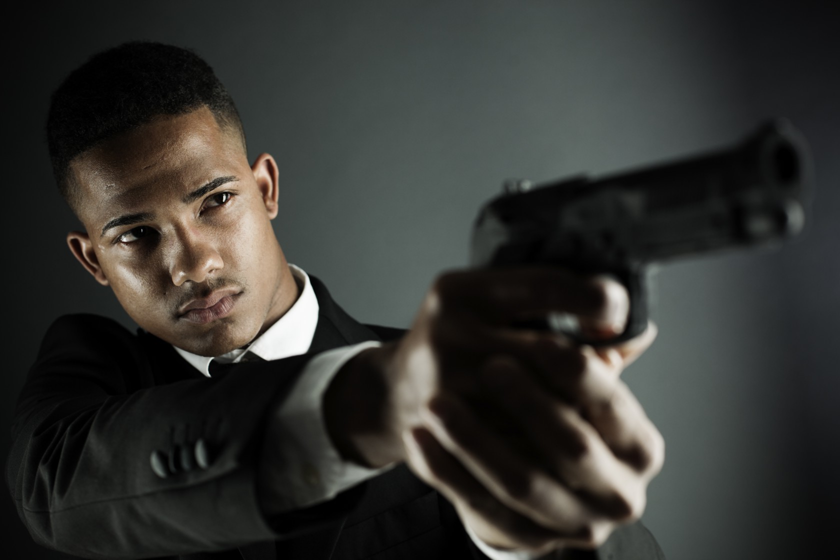 Security agent or criminal holding a hand gun.