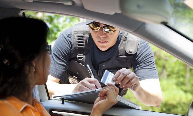 Crime: Policeman gives driver a traffic ticket.