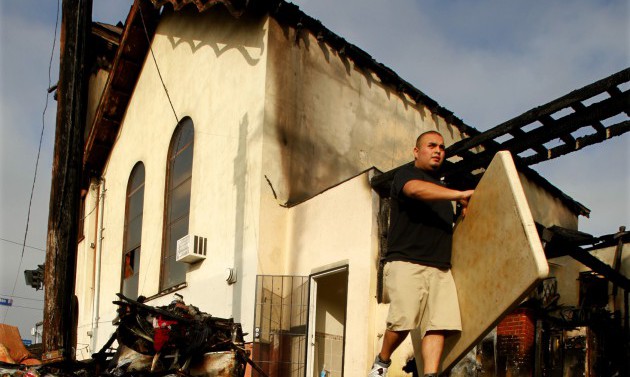 Volunteers help to salvage tables, chairs and other items that were not burnt in the fire that dest