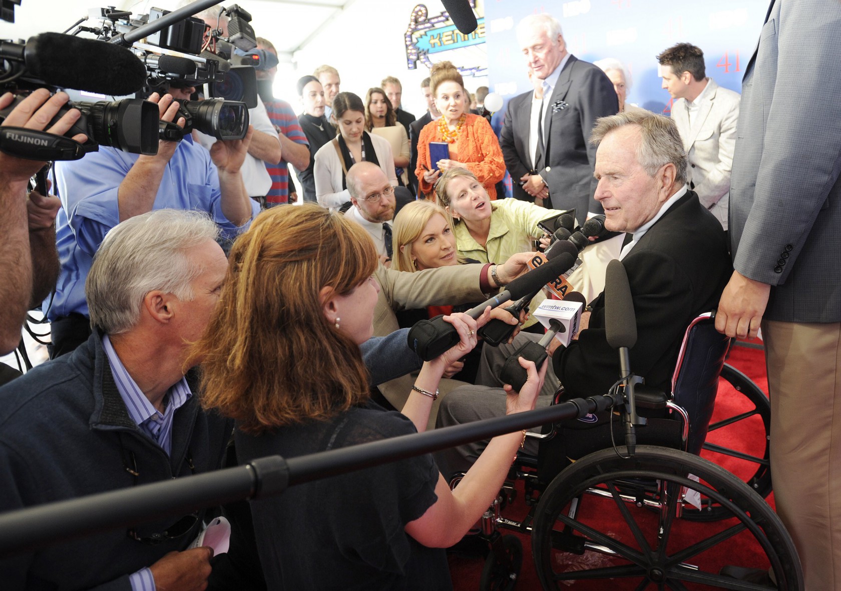 George H.W. Bush is interviewed by reporters while on the red carpet for a special screening of 41,