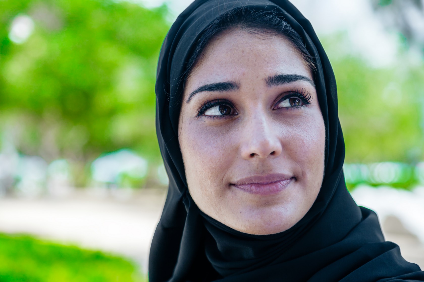 Beautiful Arab woman in smiling portrait outdoor