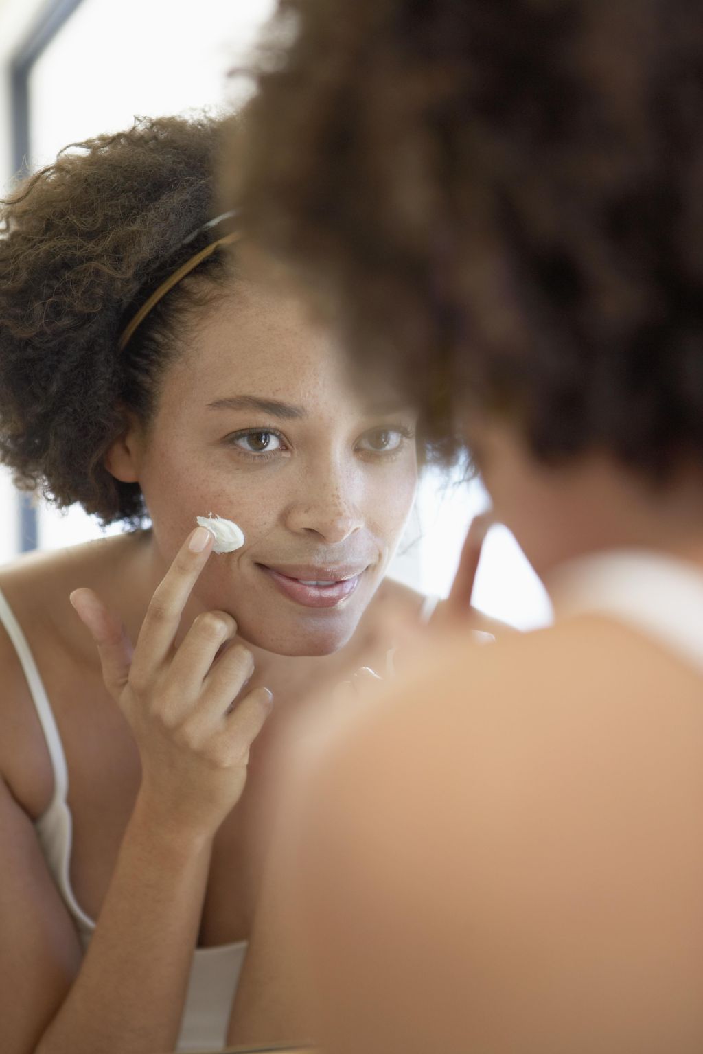 Woman Moisturizing Face