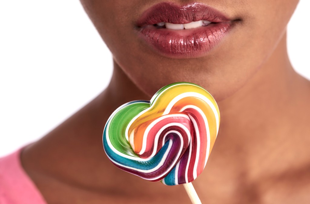 close up of a mouth and lollipop
