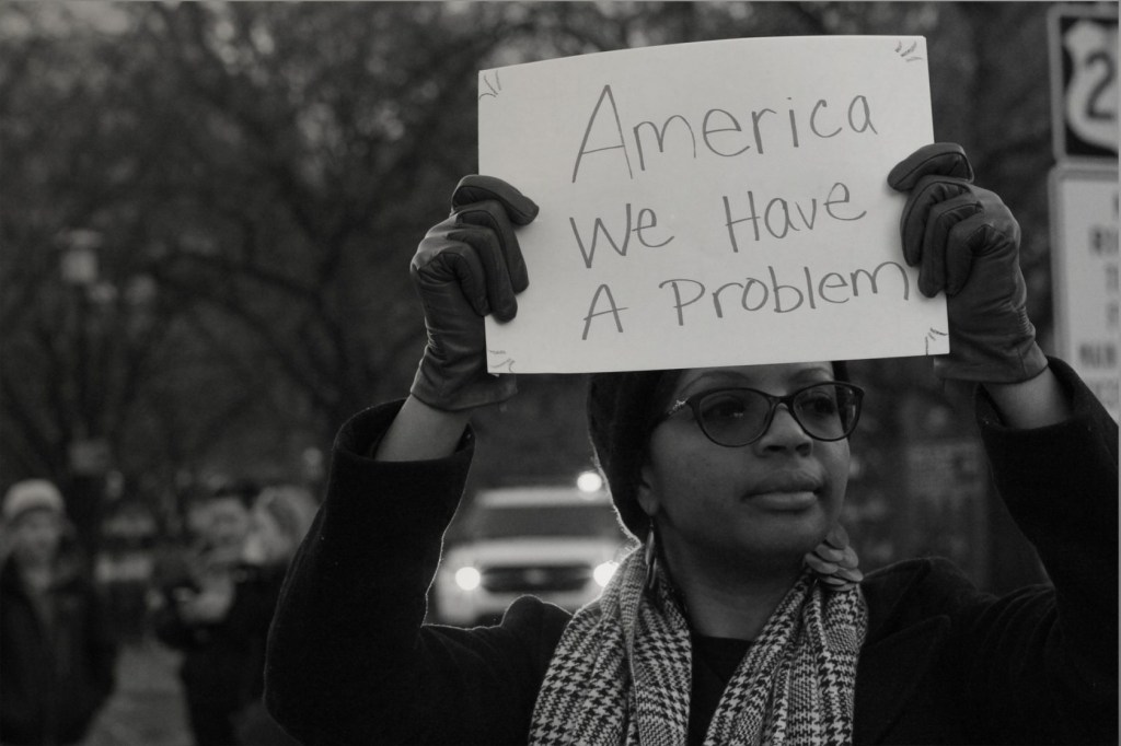 Black Woman Holding Protest Sign