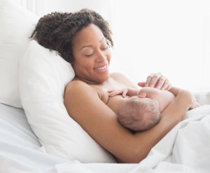 Mixed race mother nursing newborn baby
