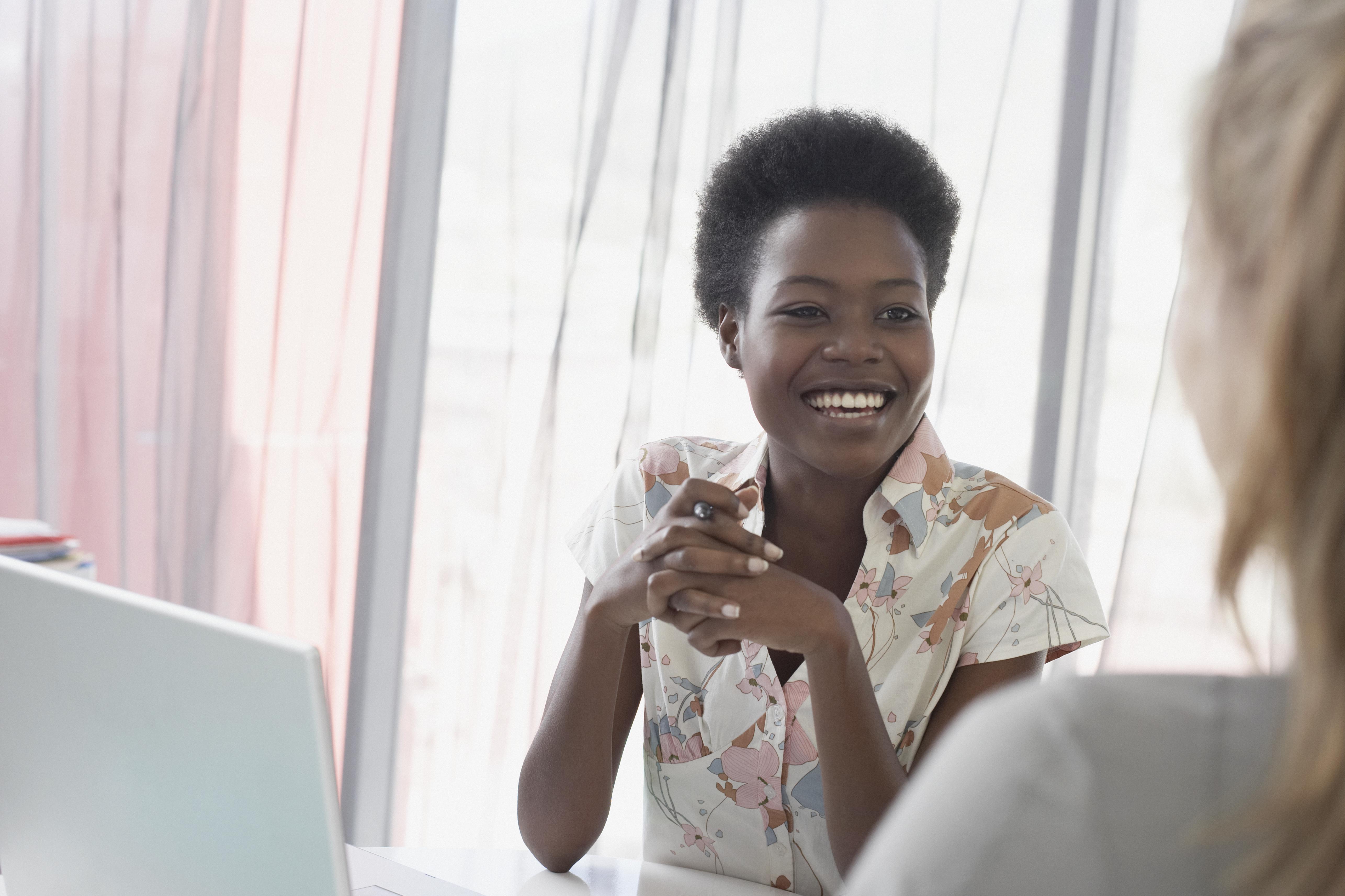 Two women talking in office