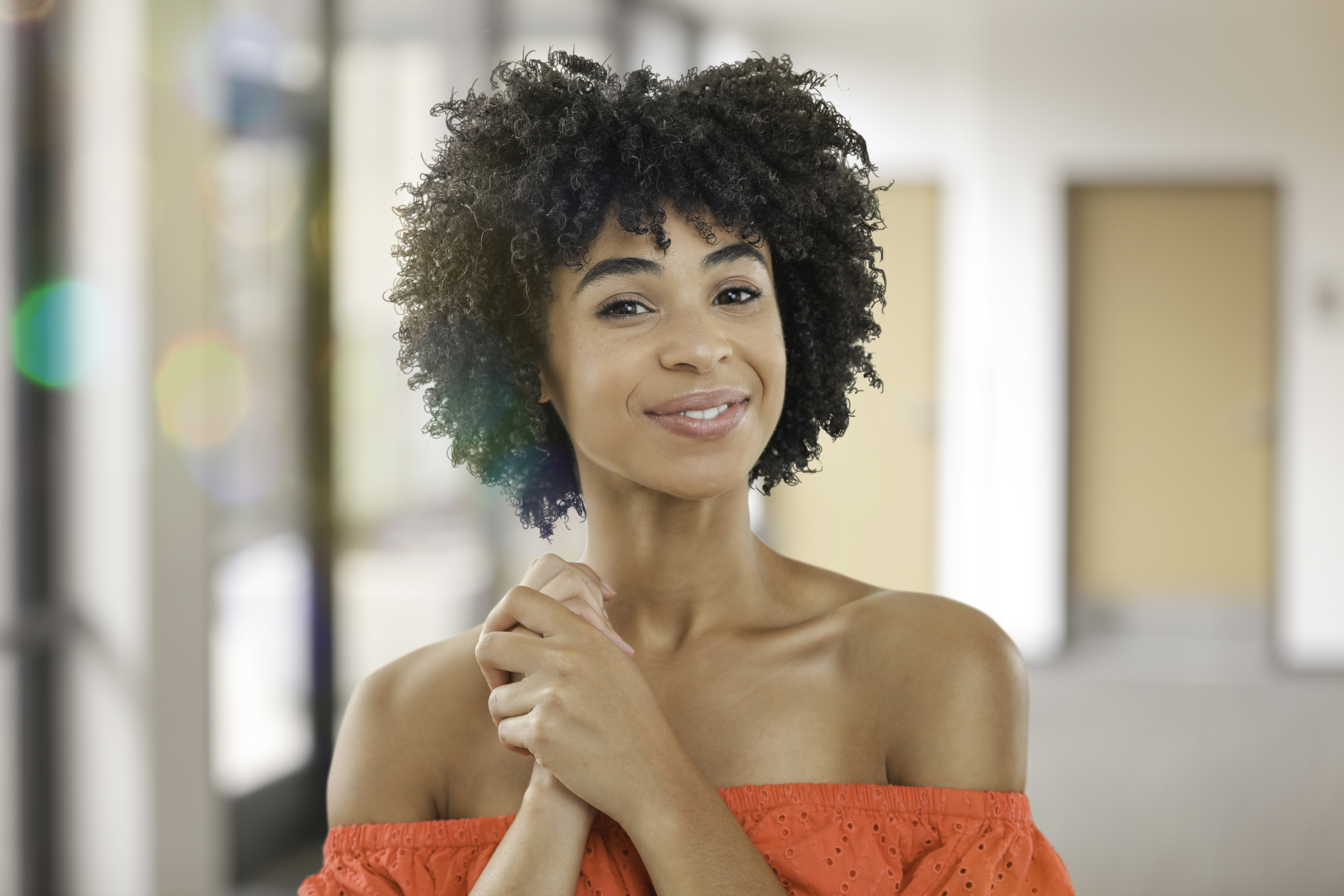 Smiling young woman in dress in office
