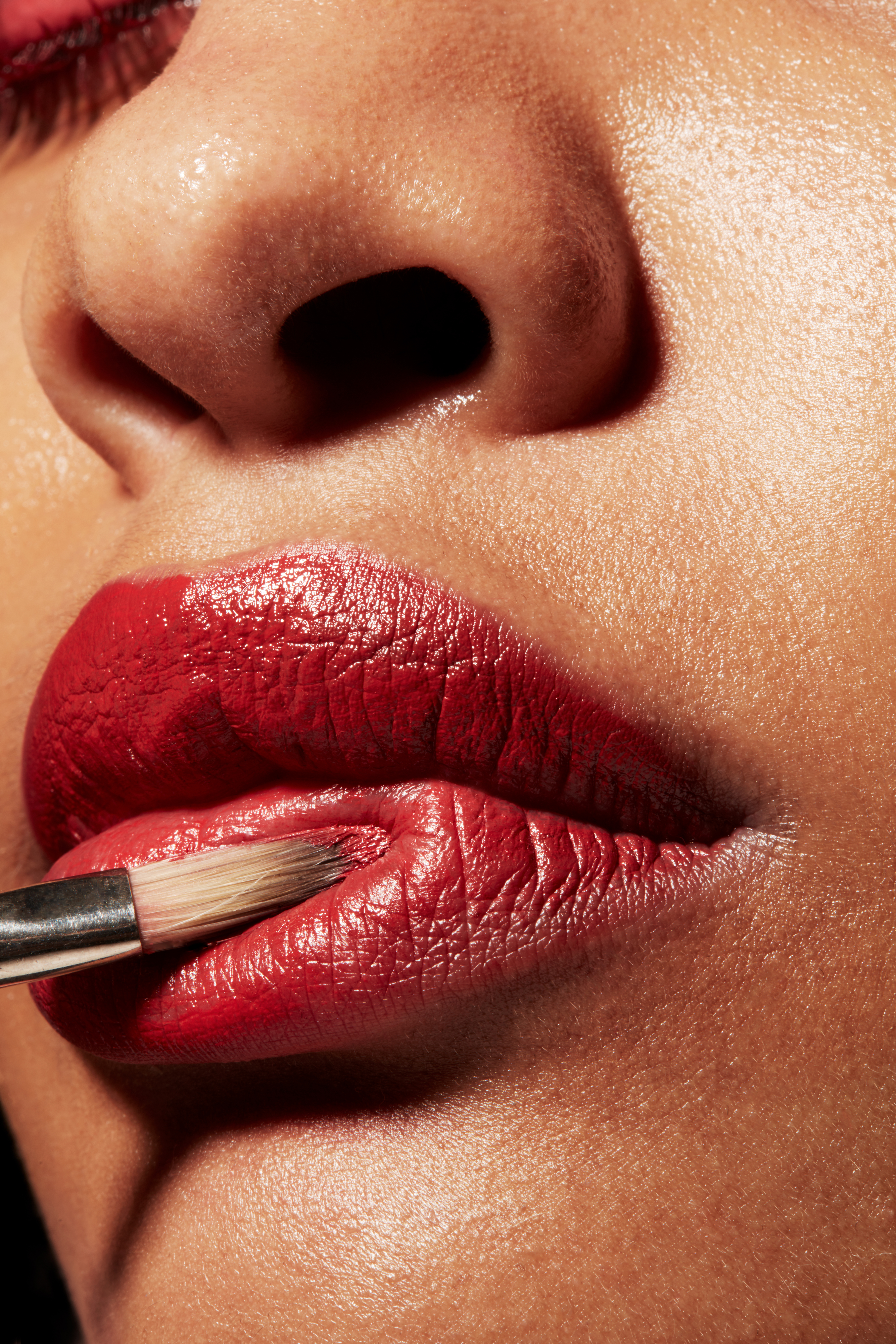 Tight beauty shot of womens face. Red lipstick and red makeup