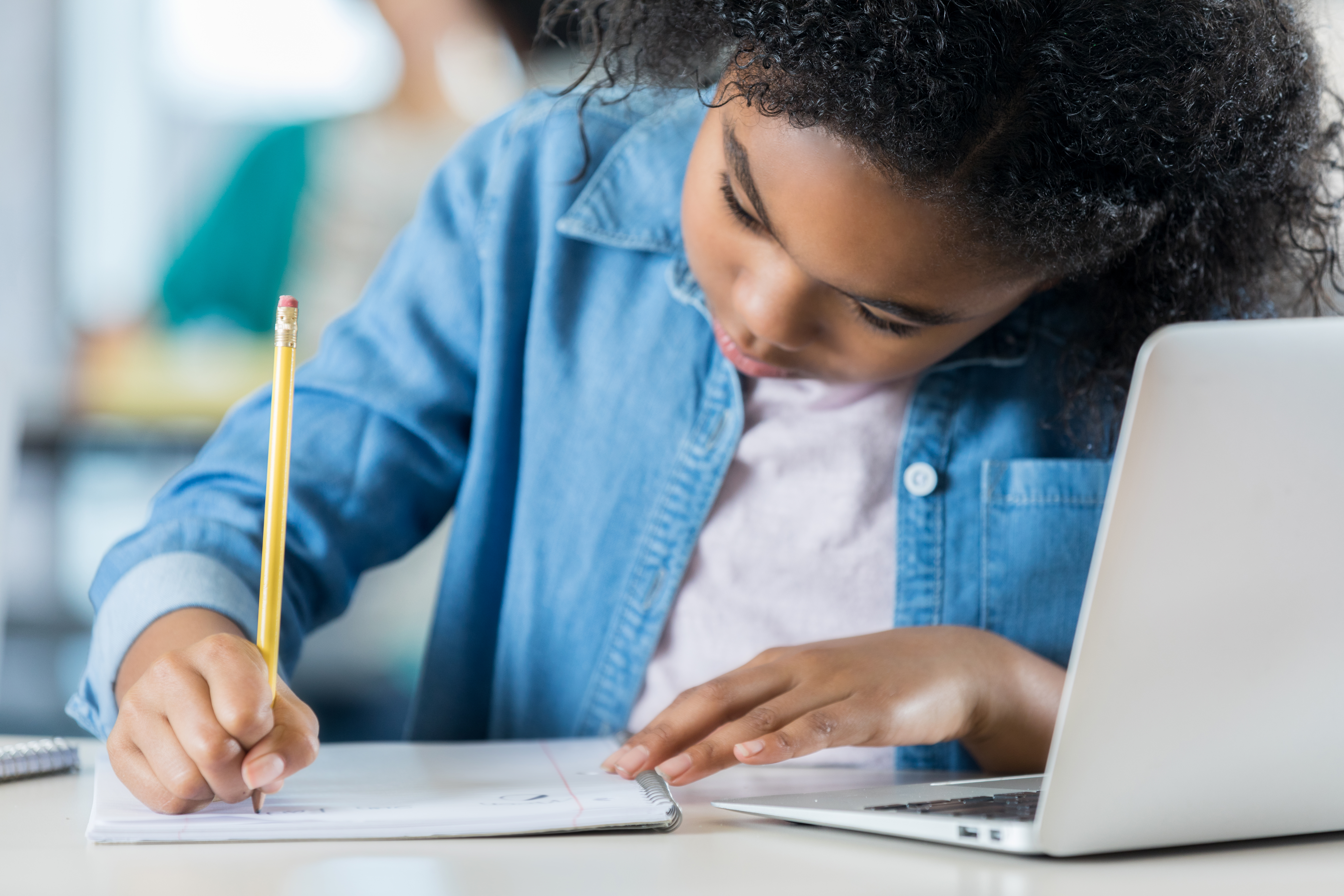 Schoolgirl working on class assignment