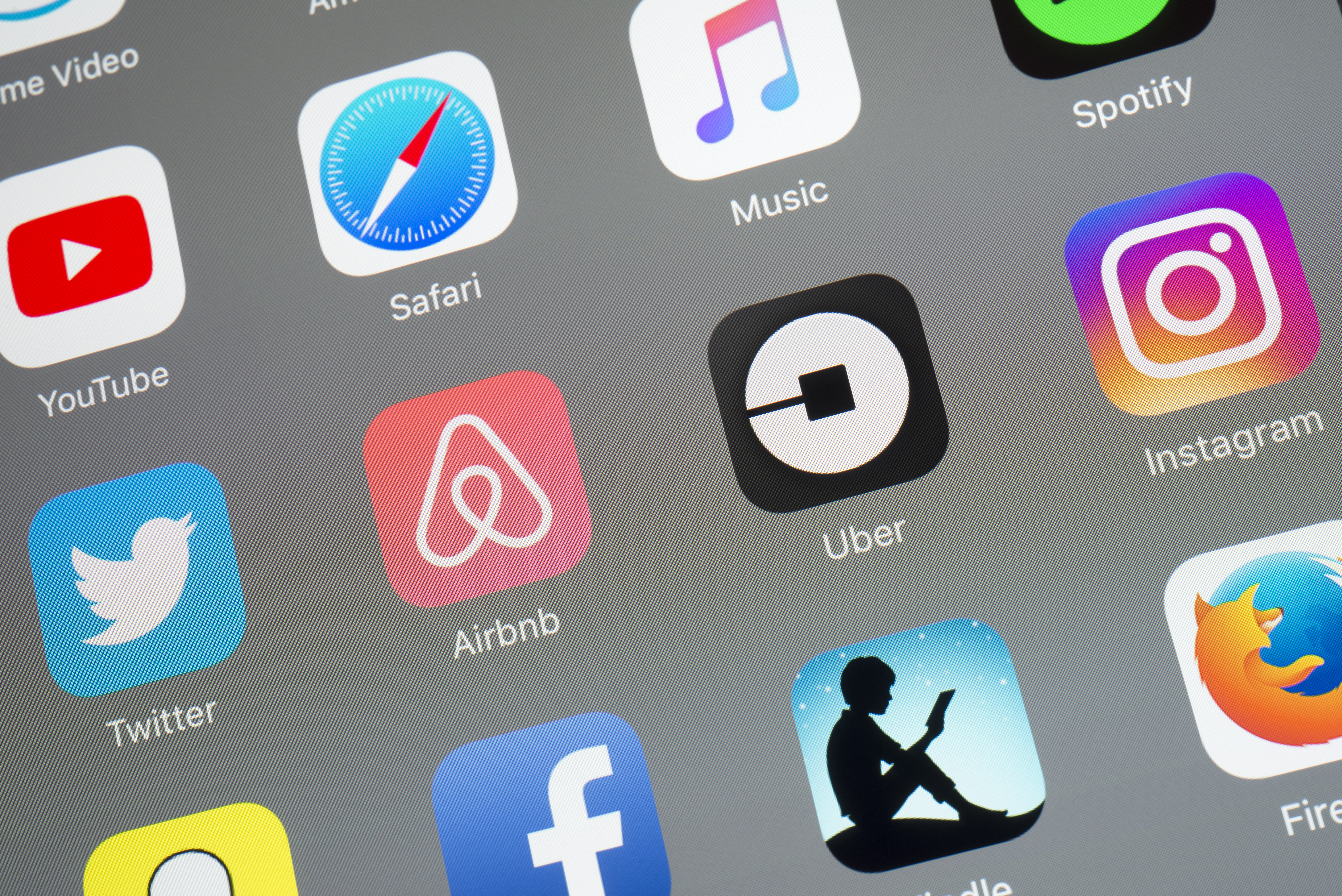 The buttons of the Apps 'Airbnb' and 'Uber' and other Apps on a digital tablet screen