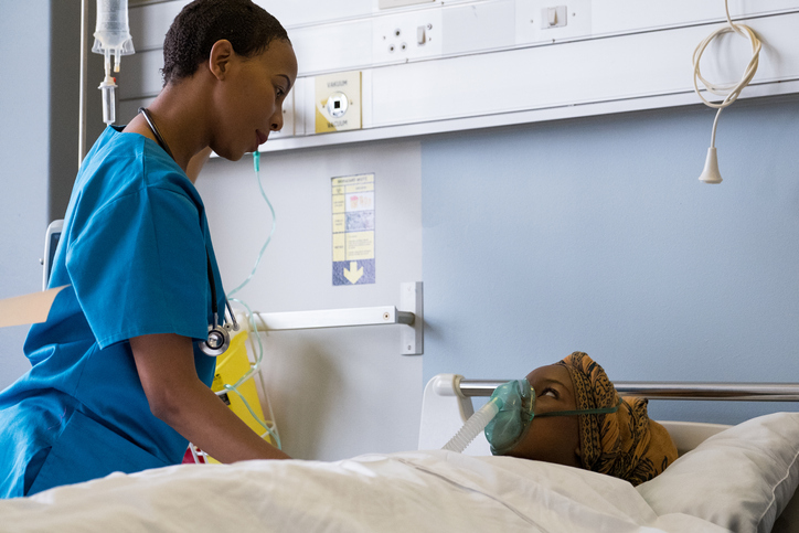 African doctor attends to her patient