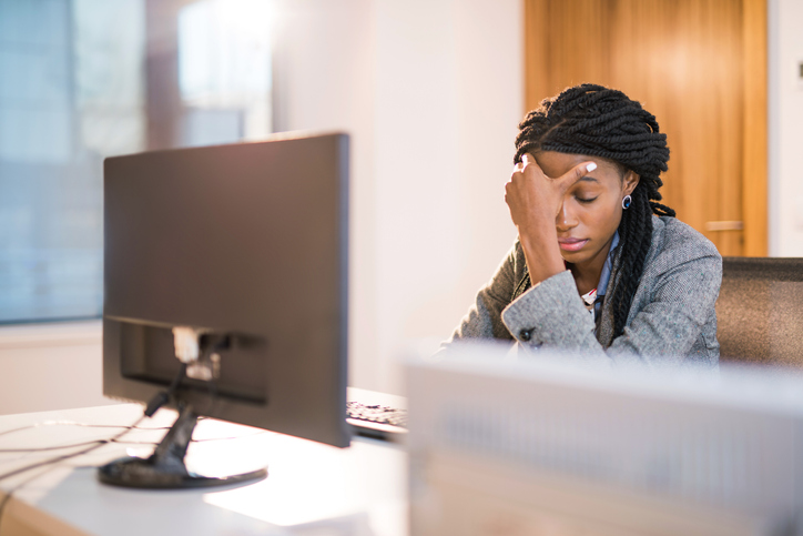 Depressed African woman at work.