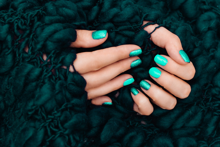 manicure in mint color on the white mint background