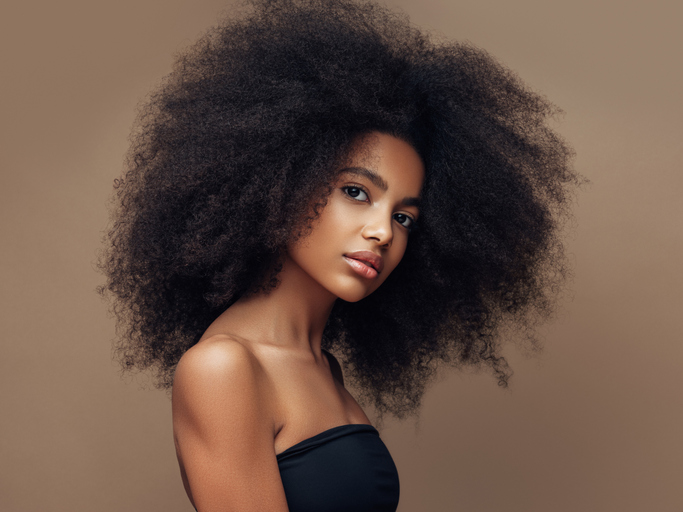 Beautiful smiling girl with curly hairstyle