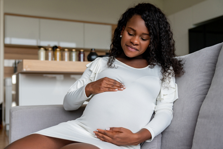Beautiful woman expecting a baby and relaxing at home