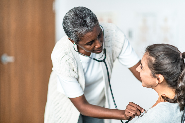 Female Doctor Examines Patient stock photo