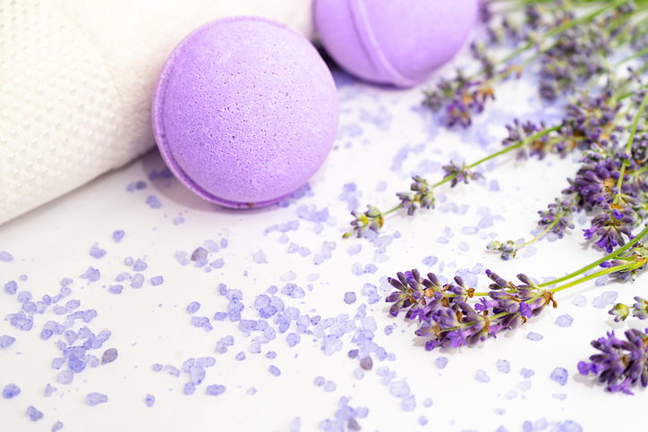 Lavender flowers and beauty products isolated on white background.