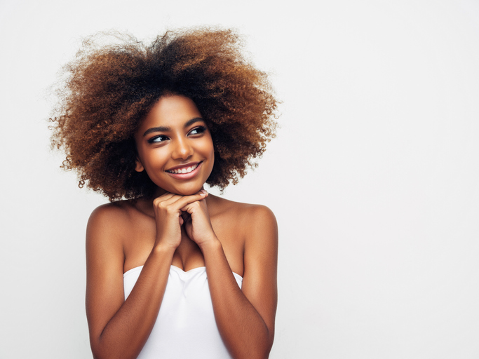 Beautiful smiling girl with curly hairstyle