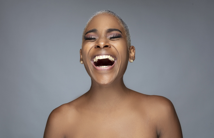 Portrait of afro young woman with short blonde hair.