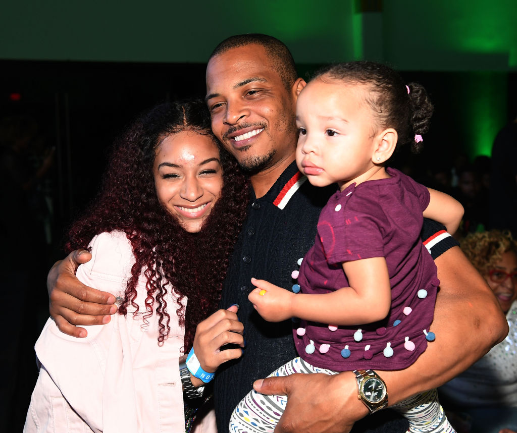 TI, Deyjah Harris and Heiress Harris hugging at the "The Grand Hustle" Viewing Party