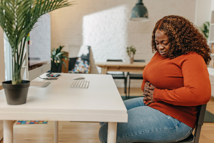 Young African-American woman having stomach pain