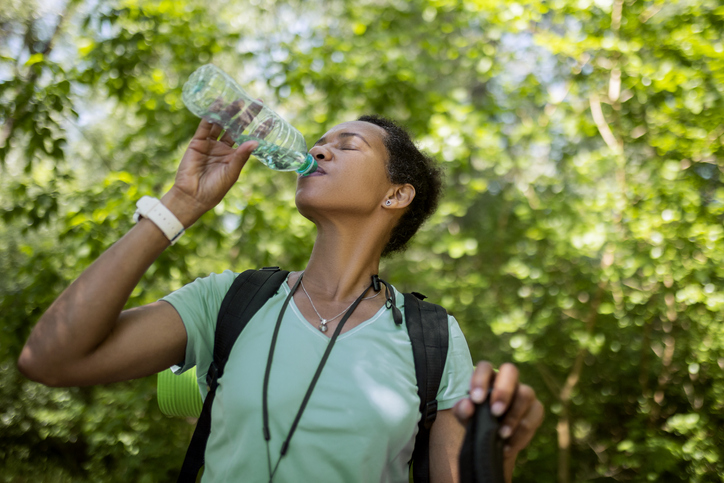 Tired Hiker Woman In Forest Hydrating