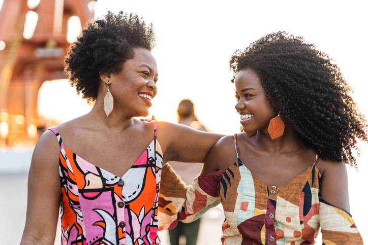 Black traveler Smiling women in the city at sunset