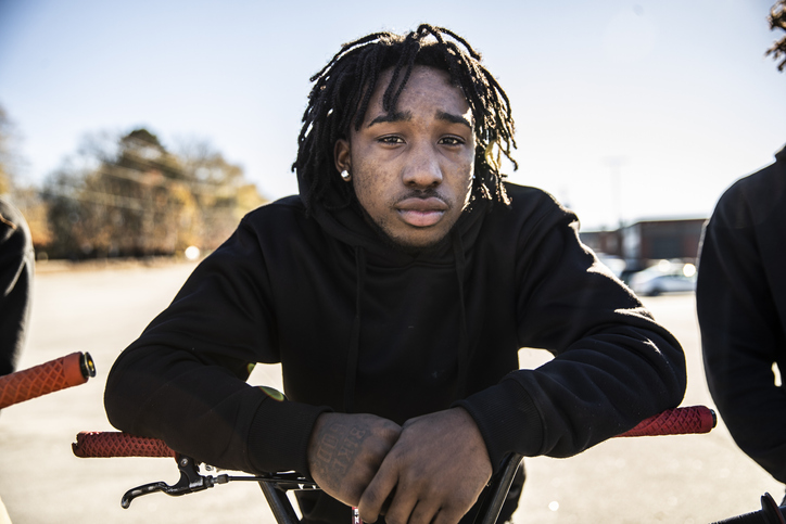 Portrait of young male BMX riders in urban area