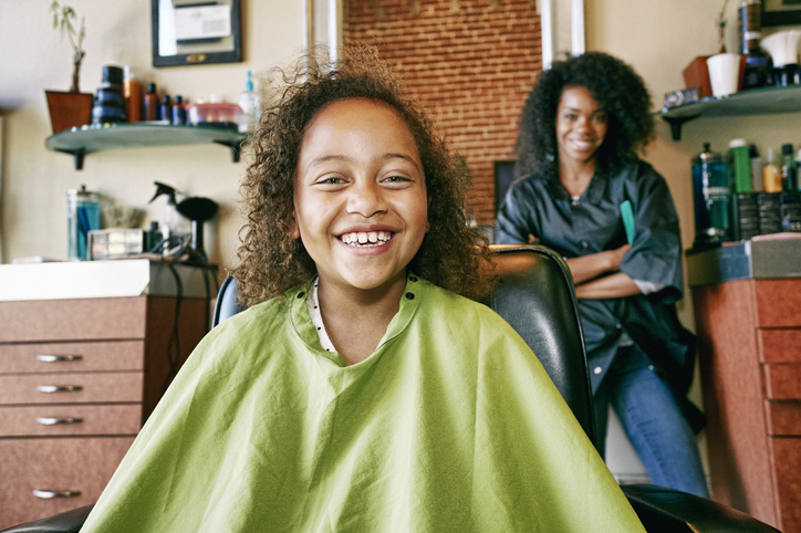Smiling hairdresser and customer in hair salon