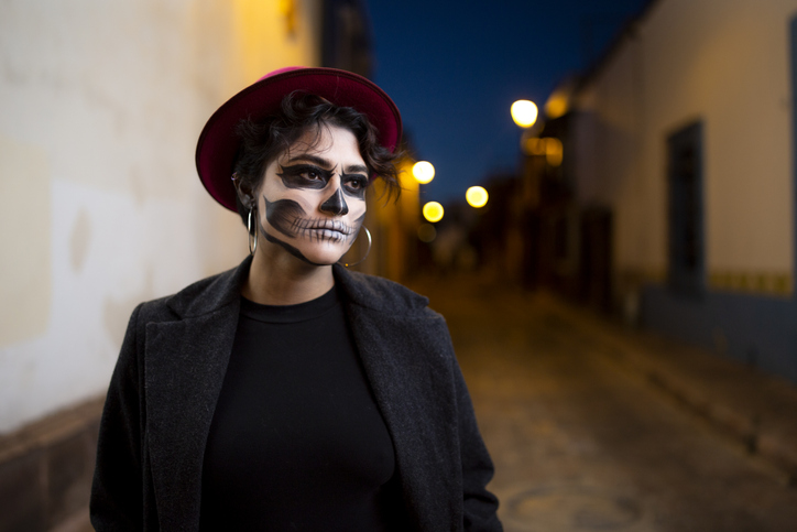 Woman in skull makeup on the street