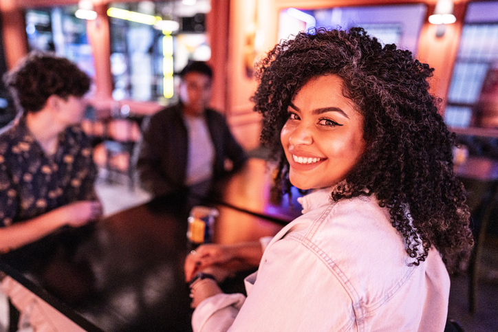 Portrait of a mid adult woman with friends on a restaurant