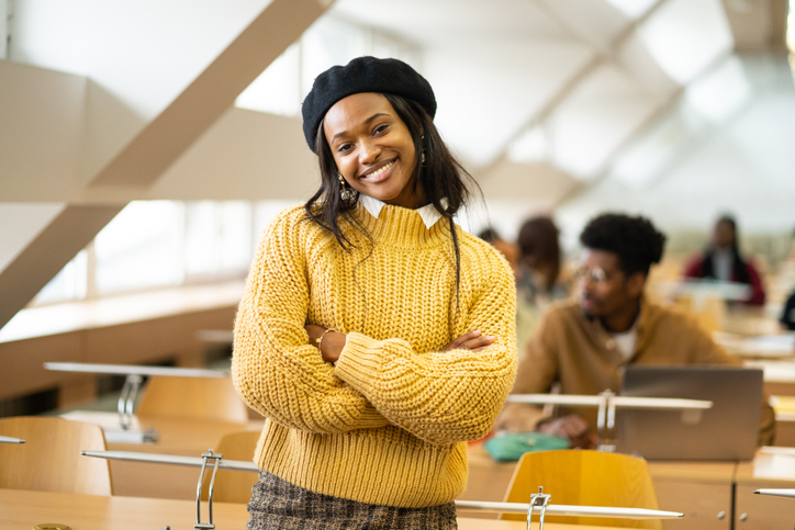 Portrait of an African female scholar standing in modern classroom