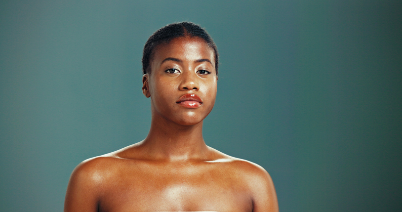 Portrait, skincare and confident black woman with beauty, glow and shine on studio background. Face, serious and African model in makeup cosmetics for dermatology, aesthetic and spa facial treatment