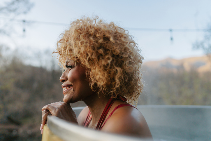 Beautiful African American woman in a garden hot tub hot tub