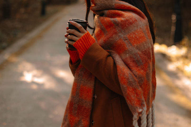 Autumnal fashion details of warm brown coat and bright orange scarf, autumn lifestyle