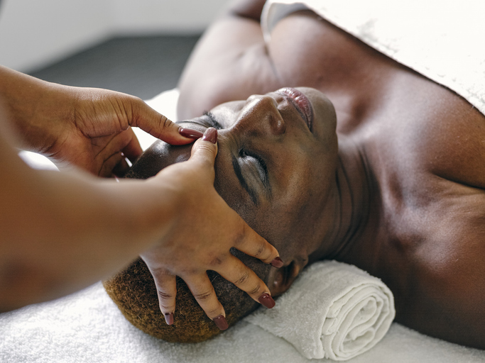 UK, Mature woman having head massage